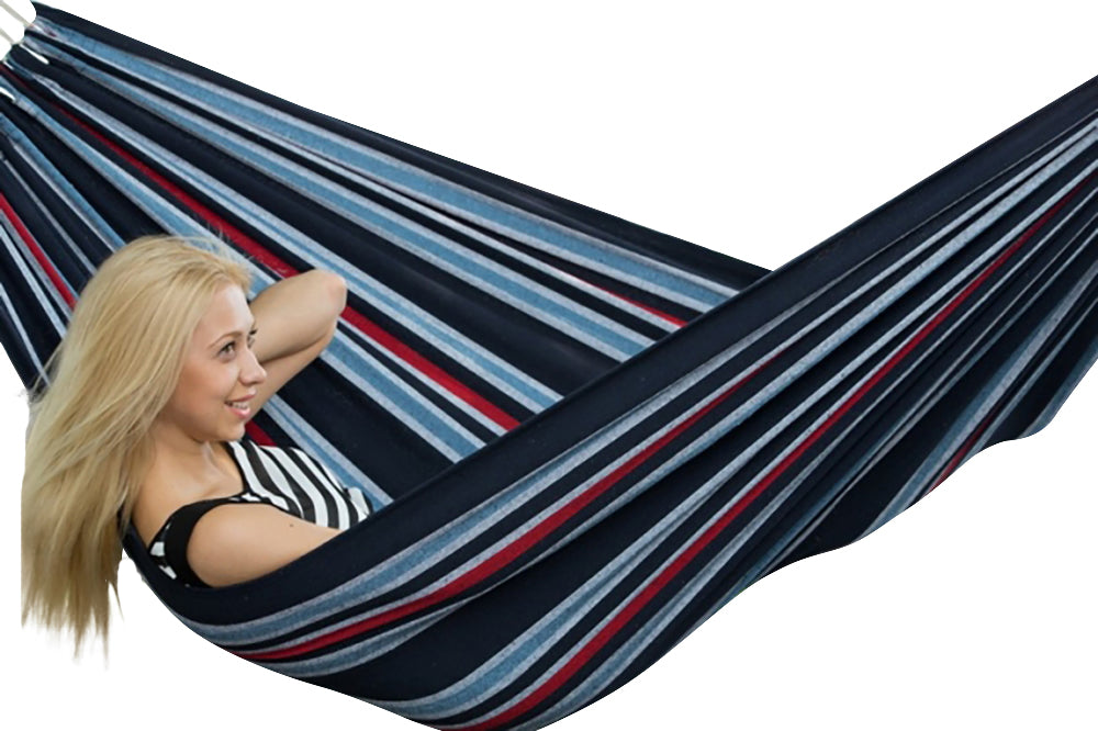 Woman relaxing in a striped hammock on a white background,20167