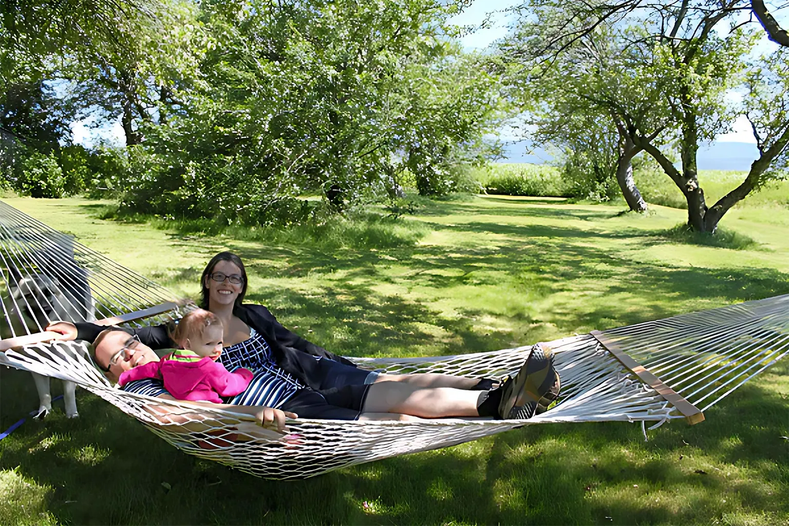 Woman and child relaxing in a hammock in a park 50501-PWT