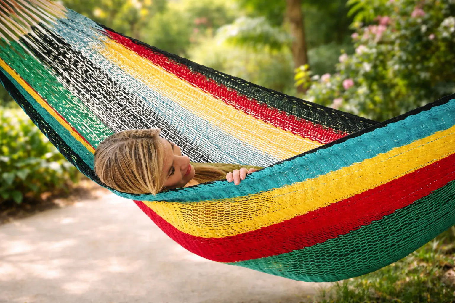 Colorful hammock with a person relaxing in a garden setting #24-MHXLTC-H