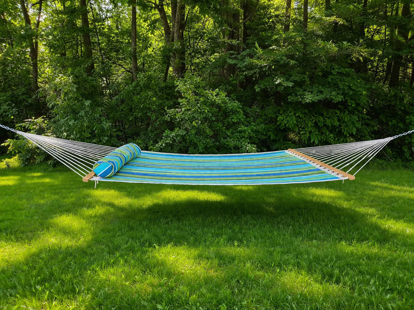 Blue and green striped hammock on grass with trees in the background QHD-CAROLINA