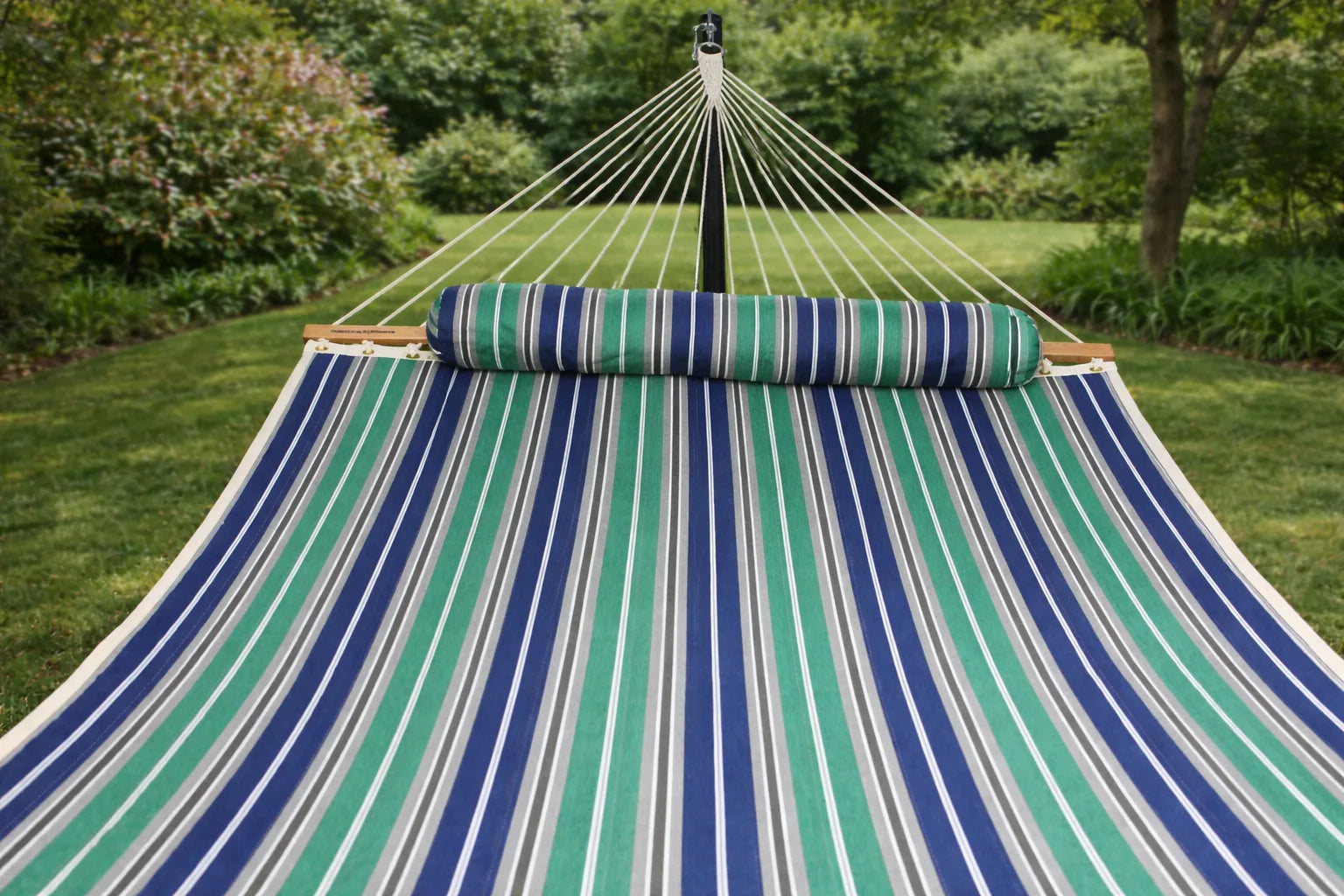 Striped hammock with rolled-up pillow in a garden setting QHD-GBGW